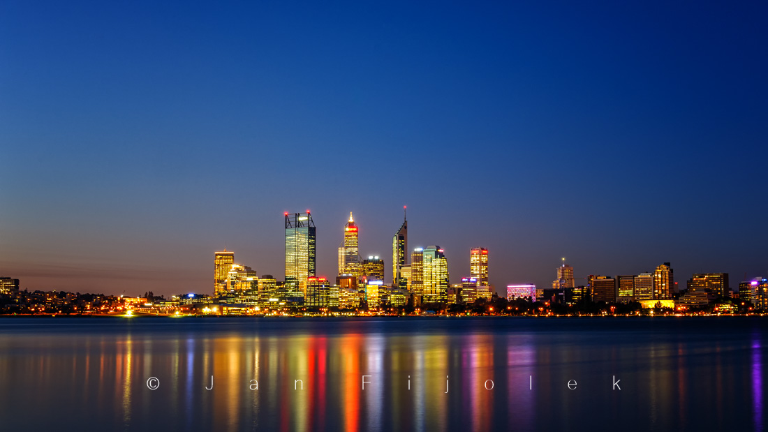 Perth City skyline reflecting in Swan River at sunset