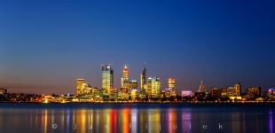 Perth City skyline reflecting in Swan River at sunset