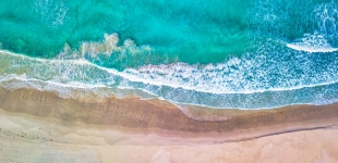 Drone aerial view of ocean waves washing on the beach, Esperance Western Australia.