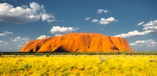Ayers Rock, the famous Australian landmark in the middle of the sunny day.