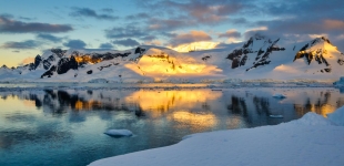The Sunset reflecting from the snowy mountains of Antarctic Peninsula